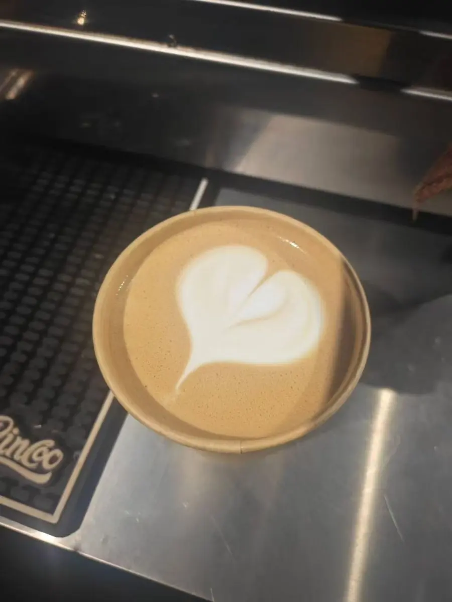 Heart latte art in a takeaway cup